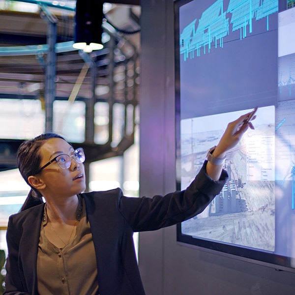 Women looking at graphs on TV screens